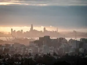 View of Oakland at sunset from the hills with San Francisco is the backgroun
